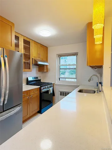 a kitchen with stainless steel appliances granite countertop a sink stove and refrigerator