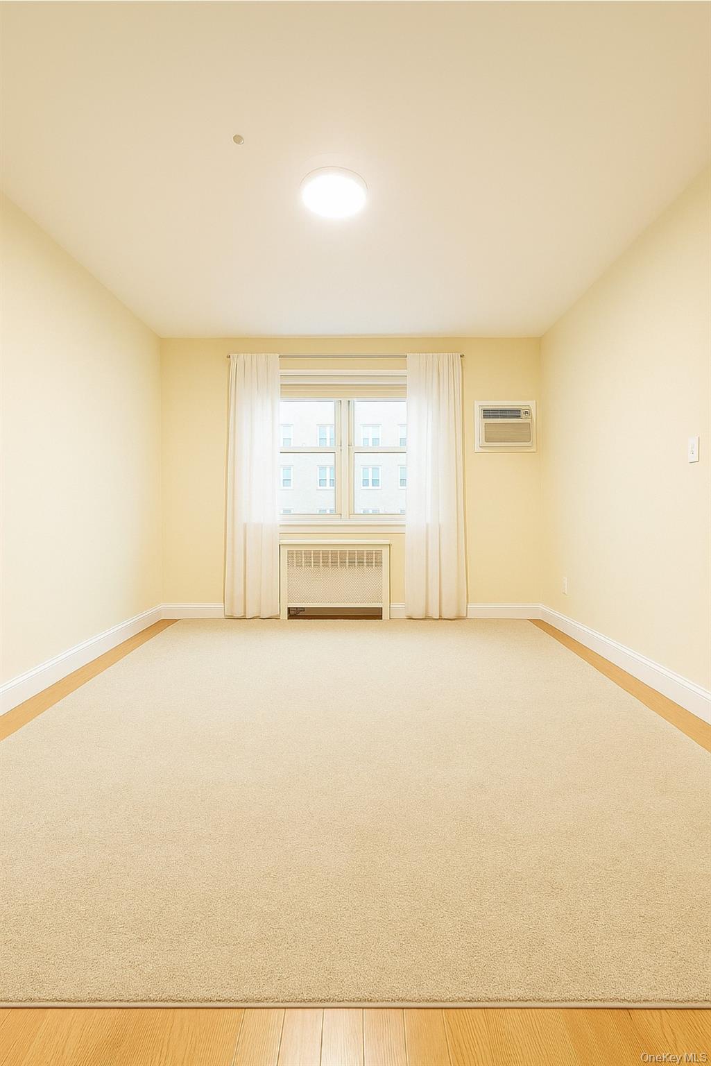 152-44 Jewel Avenue, Unit 102A Queens, NY 11367 - Photo 6 of 12 a view of an empty room with a window