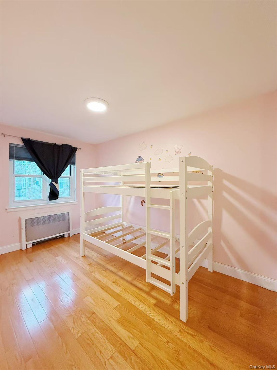 152-44 Jewel Avenue, Unit 102A Queens, NY 11367 - Photo 7 of 12 a view of a room with wooden floor and stairs