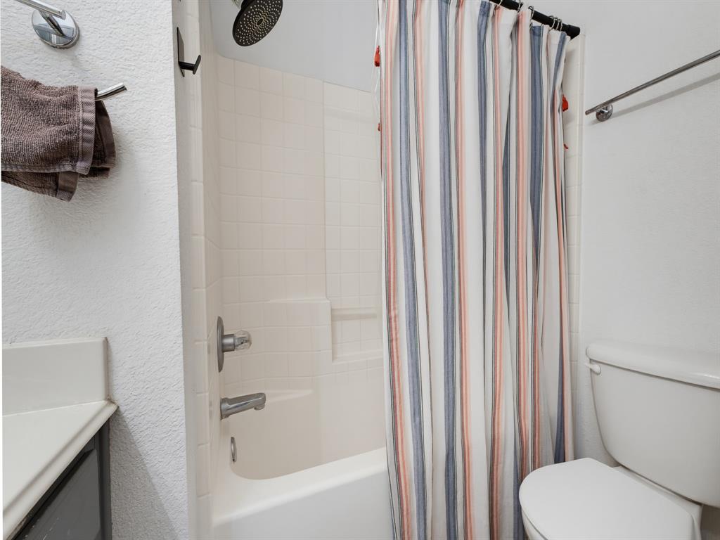 600 Stirling Road Rhome, TX 76078 - Photo 26 of 38 Tub and shower combination featuring a rainfall showerhead, white tiled surround, and integrated soap dish