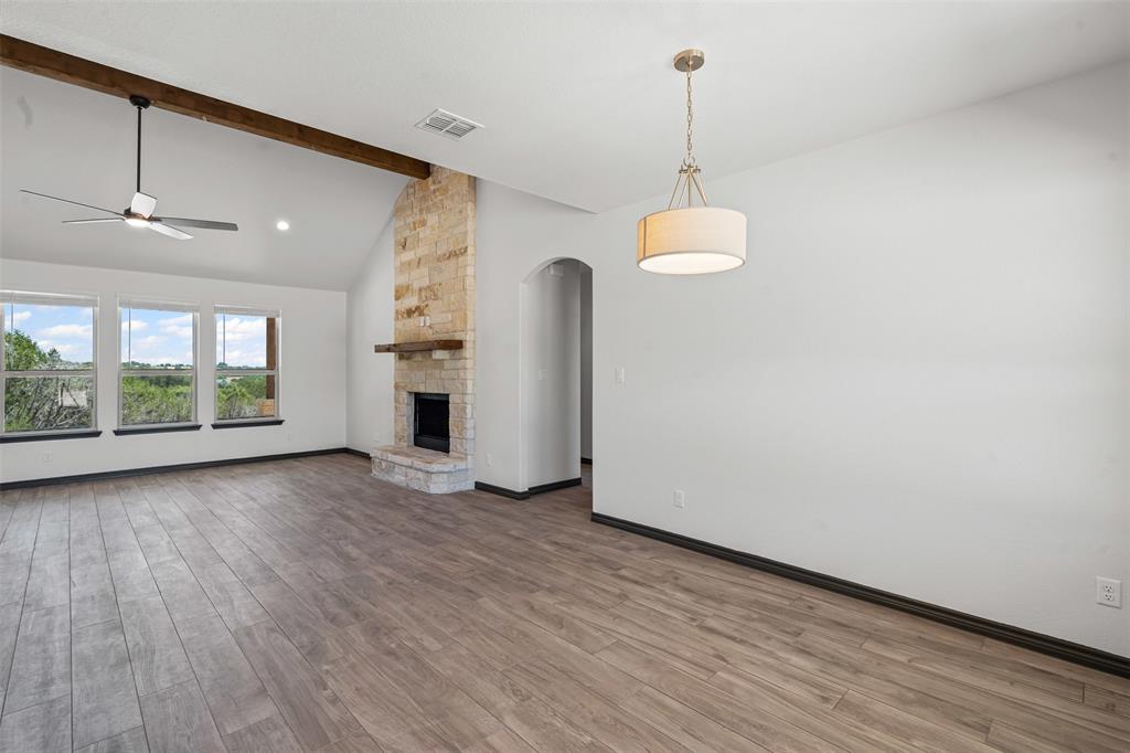 5470 Compass Way Bluff Dale, TX 76433 - Photo 11 of 26 a view of a room with wooden floor fireplace and windows