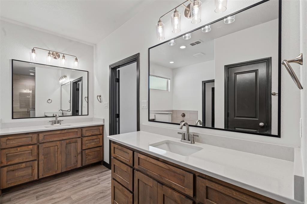 5470 Compass Way Bluff Dale, TX 76433 - Photo 17 of 26 a bathroom with a double vanity sink and a mirror