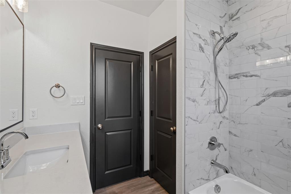 5470 Compass Way Bluff Dale, TX 76433 - Photo 19 of 26 a bathroom with a sink and shower