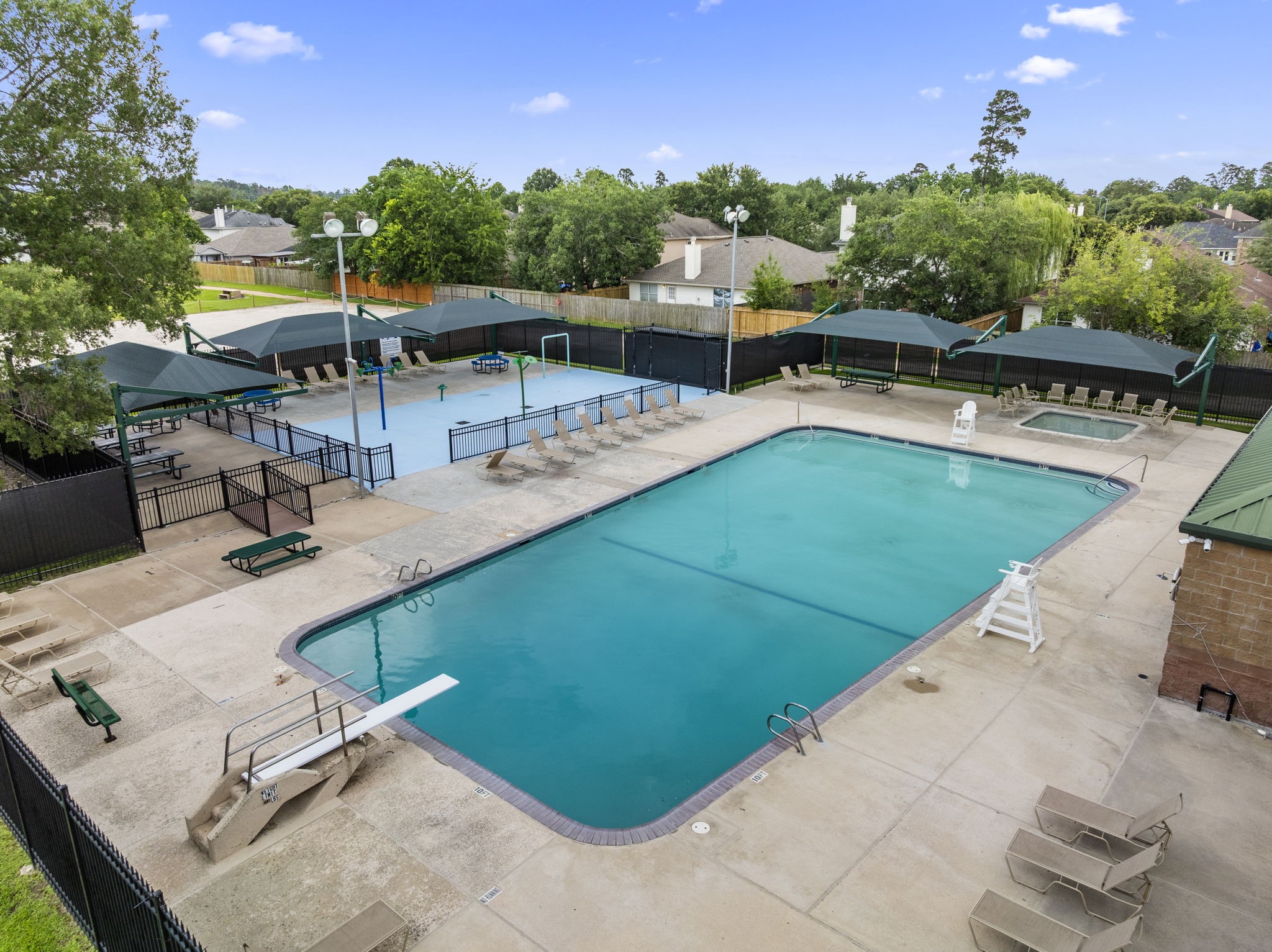 29106 Foxingham Circle Spring, TX 77386 - Photo 44 of 47 a view of a swimming pool with lawn chairs with plants