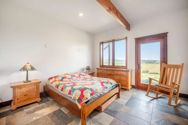 a bedroom with a bed a window and walk in closet