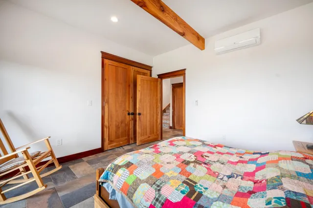 a bedroom with a bed and a lamp