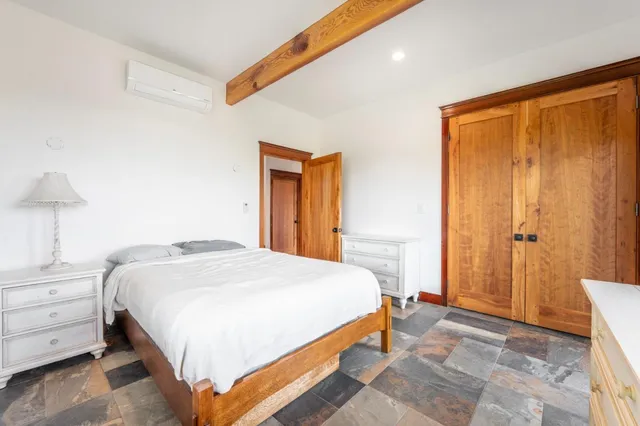 a bedroom with a bed and a lamp