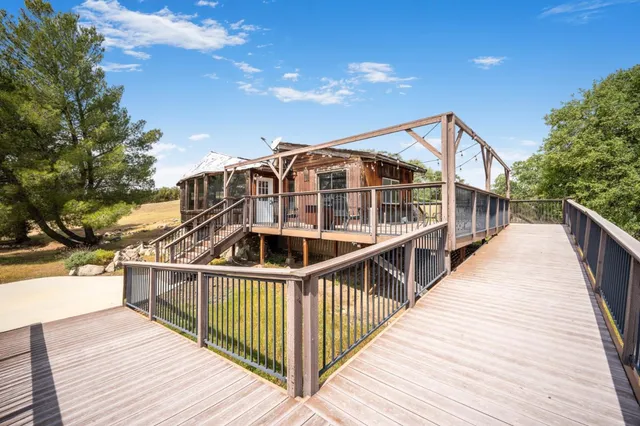 a view of a house with wooden deck