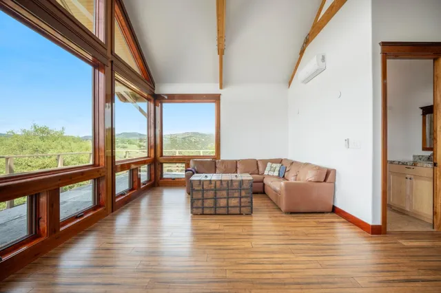 a living room with furniture and a large window