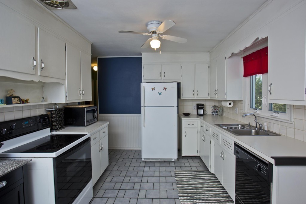 168 West Allen Ridge Road Springfield, MA 01118 - Photo 7 of 24 a kitchen with a sink a stove and refrigerator