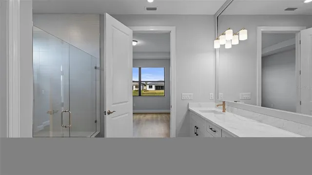 a en suite bathroom with a double vanity sink and a mirror