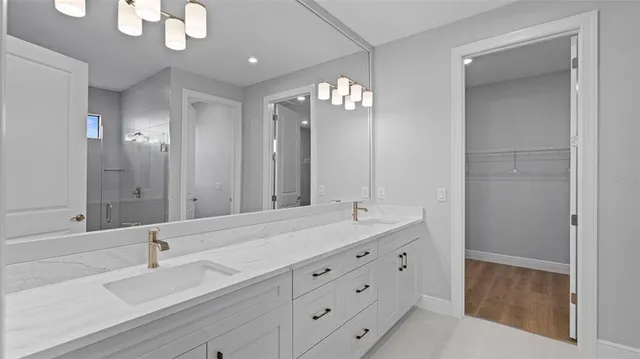 a bathroom with a double vanity sink and a mirror