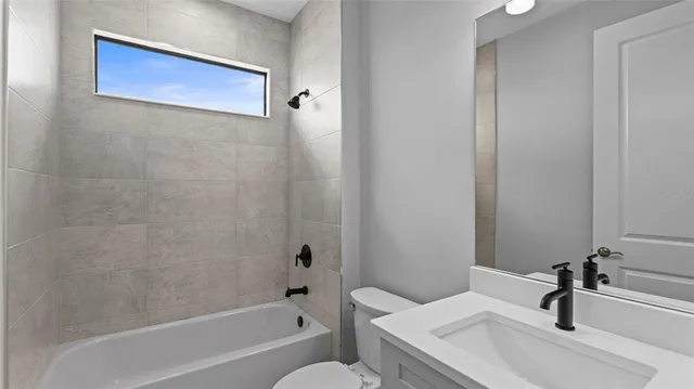 a view of a hallway with wooden floor and closet