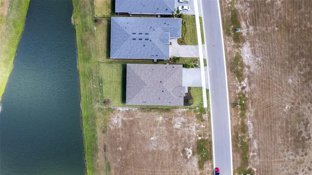 a view of a lake with houses in the back