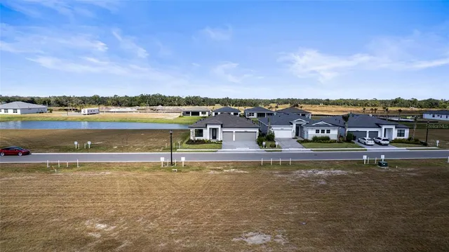 a view of a lake with houses in the background