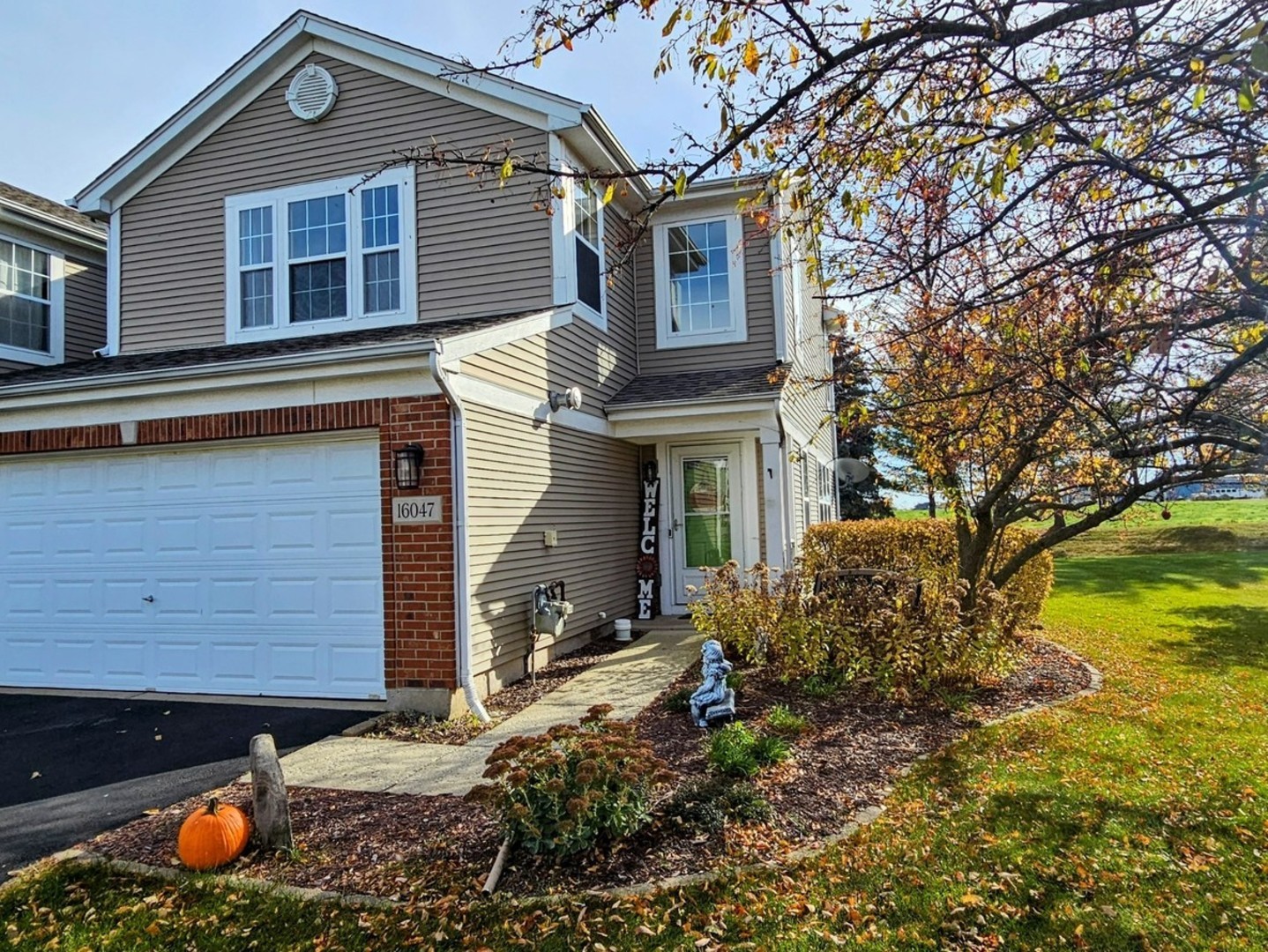 16047 Tiger Drive Lockport, IL 60441 - Photo 1 of 24 a front view of a house with garden