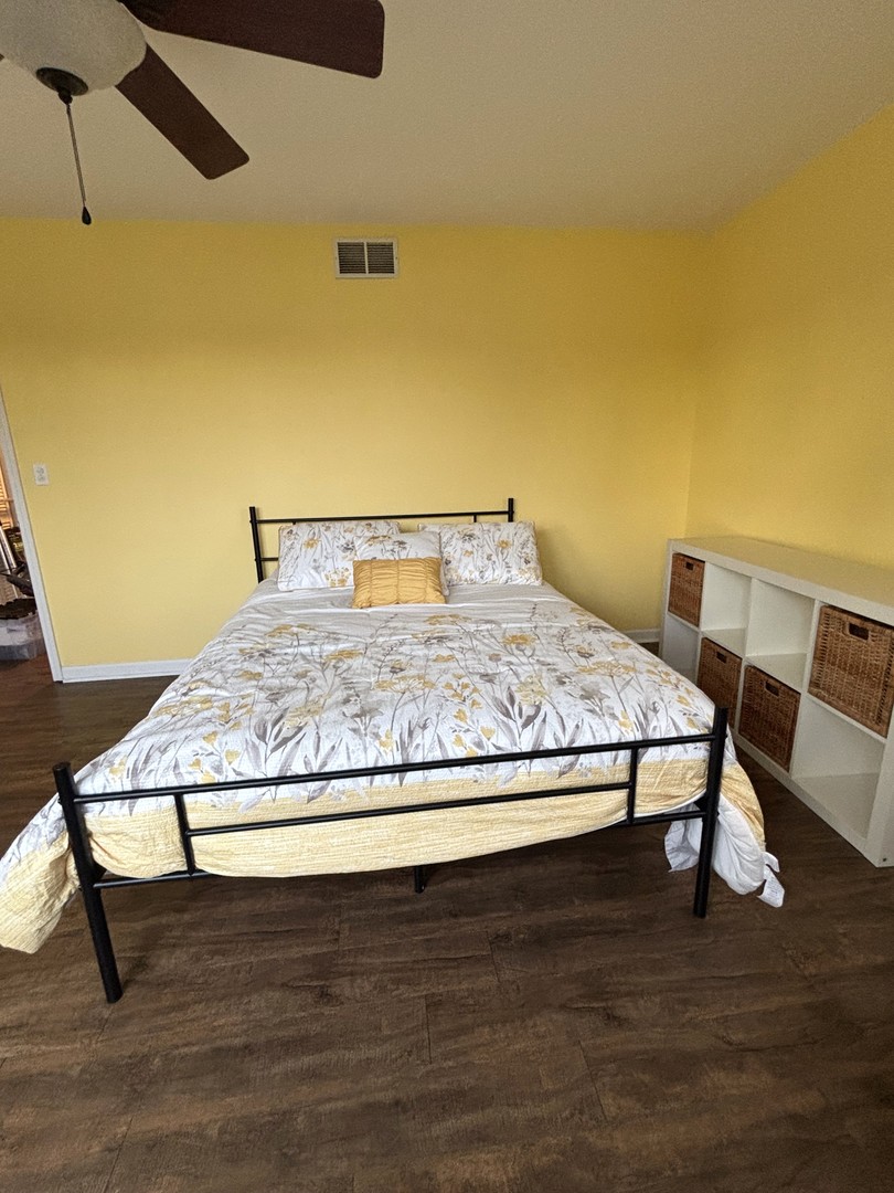 16047 Tiger Drive Lockport, IL 60441 - Photo 16 of 24 a bedroom with a bed and wooden floor