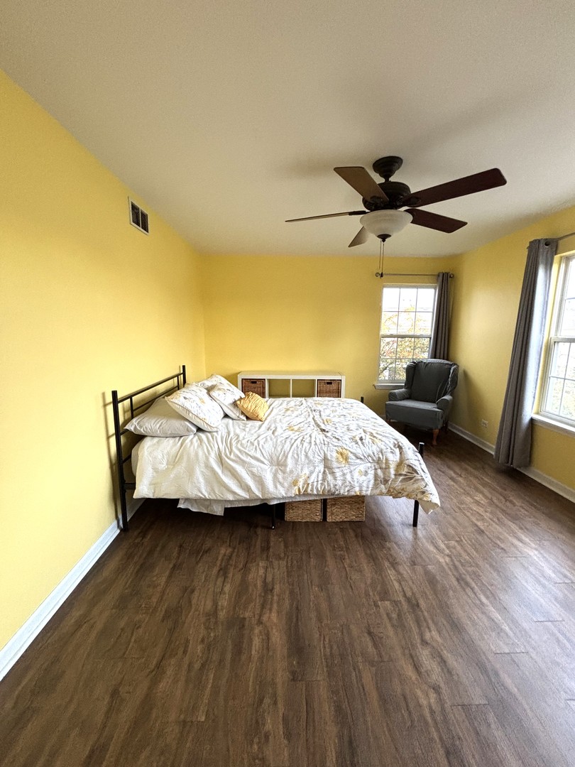 16047 Tiger Drive Lockport, IL 60441 - Photo 17 of 24 a spacious bedroom with a bed and wooden floor