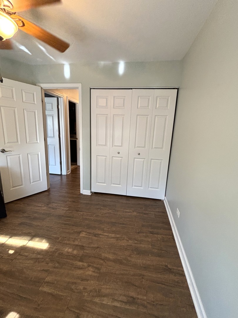 16047 Tiger Drive Lockport, IL 60441 - Photo 19 of 24 a view of an empty room with wooden floor and cabinet