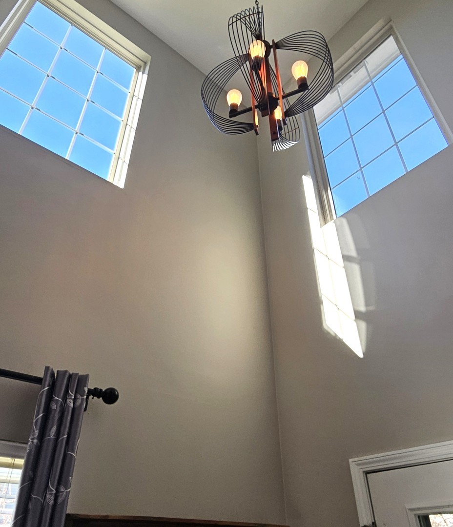 16047 Tiger Drive Lockport, IL 60441 - Photo 3 of 24 a view of a livingroom with a couch and chandelier