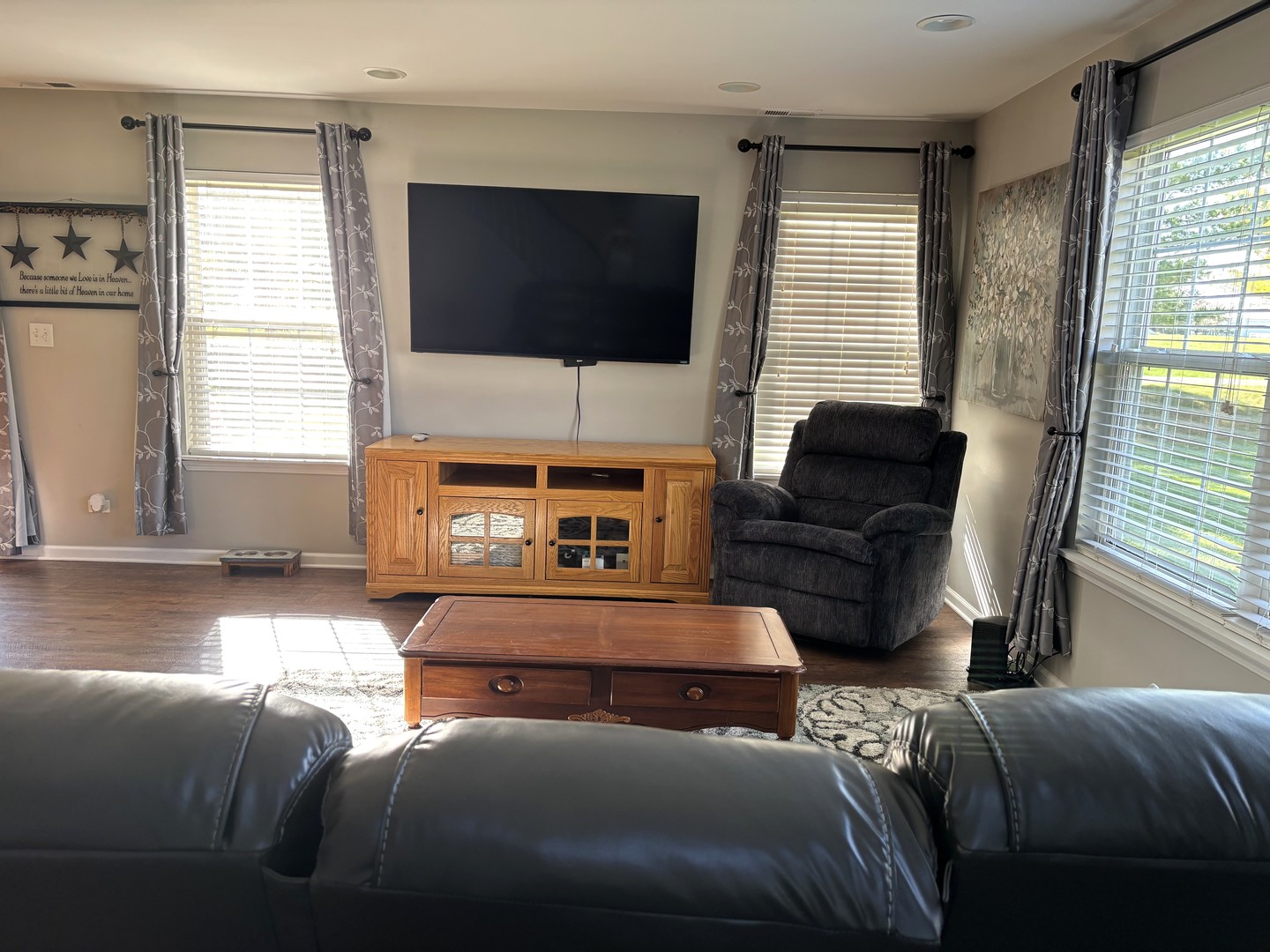 16047 Tiger Drive Lockport, IL 60441 - Photo 5 of 24 a living room with furniture a flat screen tv and a fireplace