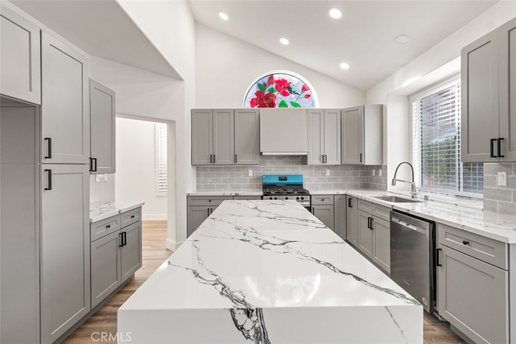14439 Grandifloras Road Canyon Country, CA 91387 - Photo 12 of 45 a kitchen with cabinets a sink and white appliances