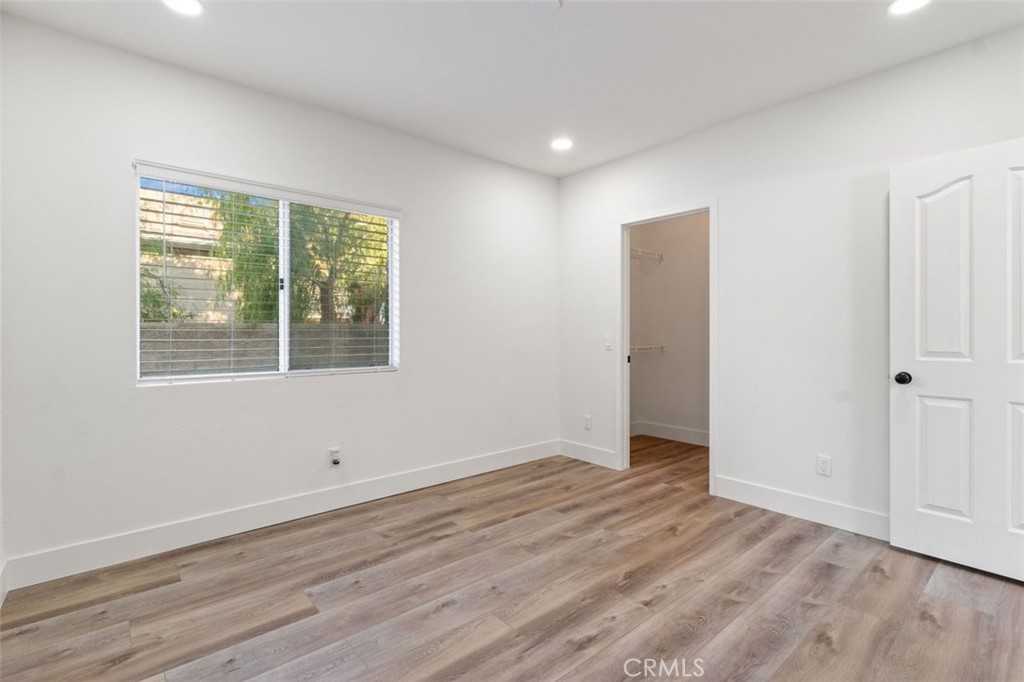 14439 Grandifloras Road Canyon Country, CA 91387 - Photo 18 of 45 a view of an empty room with wooden floor and a window