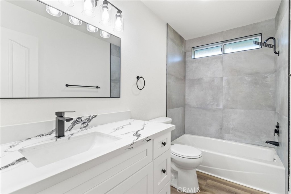 14439 Grandifloras Road Canyon Country, CA 91387 - Photo 19 of 45 a bathroom with a sink toilet vanity and shower