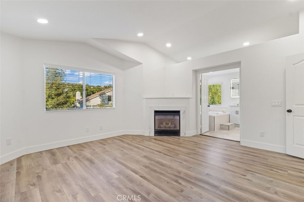 14439 Grandifloras Road Canyon Country, CA 91387 - Photo 21 of 45 a view of empty room with wooden floor and fireplace