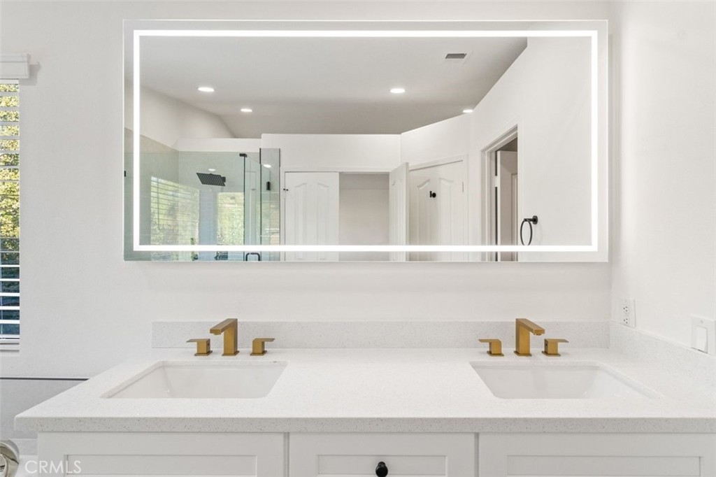 14439 Grandifloras Road Canyon Country, CA 91387 - Photo 24 of 45 a bathroom with a sink and a mirror
