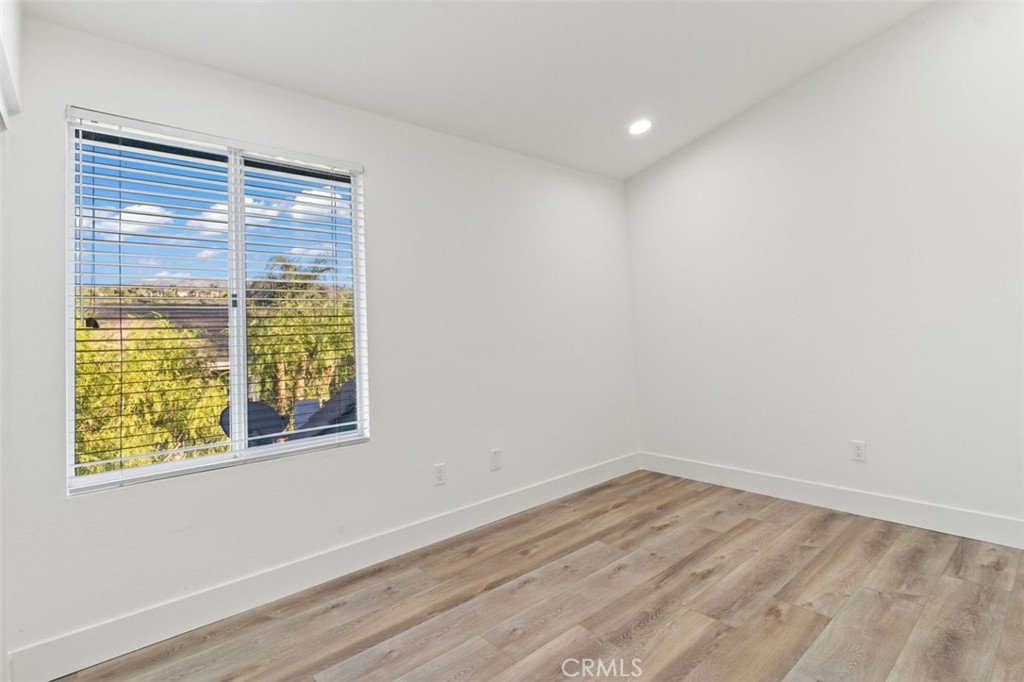 14439 Grandifloras Road Canyon Country, CA 91387 - Photo 26 of 45 a view of empty room with wooden floor and fan