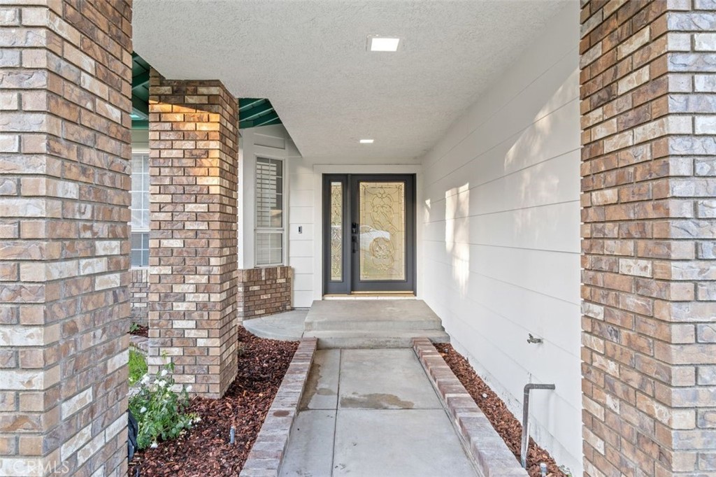14439 Grandifloras Road Canyon Country, CA 91387 - Photo 3 of 45 a view of a brick house with many windows
