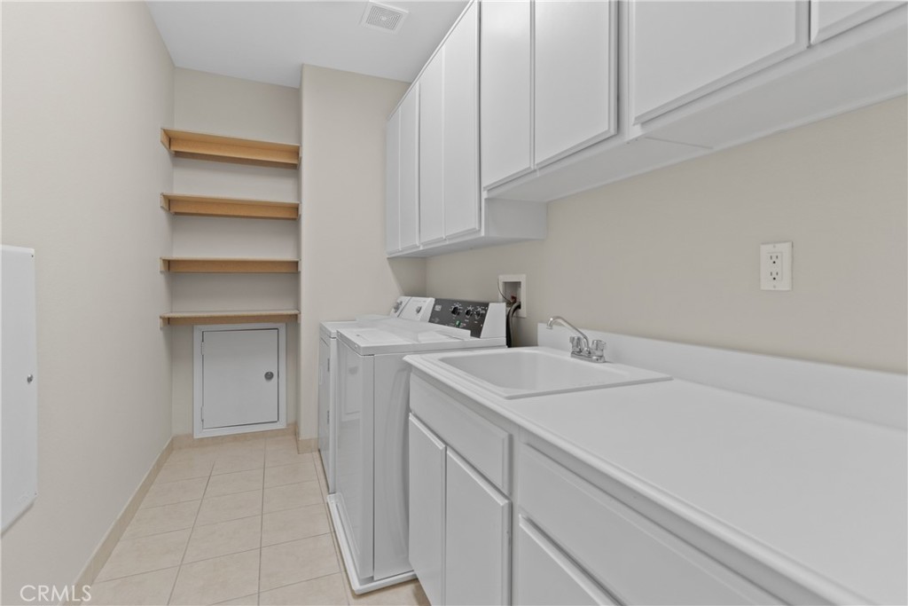 14439 Grandifloras Road Canyon Country, CA 91387 - Photo 39 of 45 a kitchen with a sink cabinets and appliances