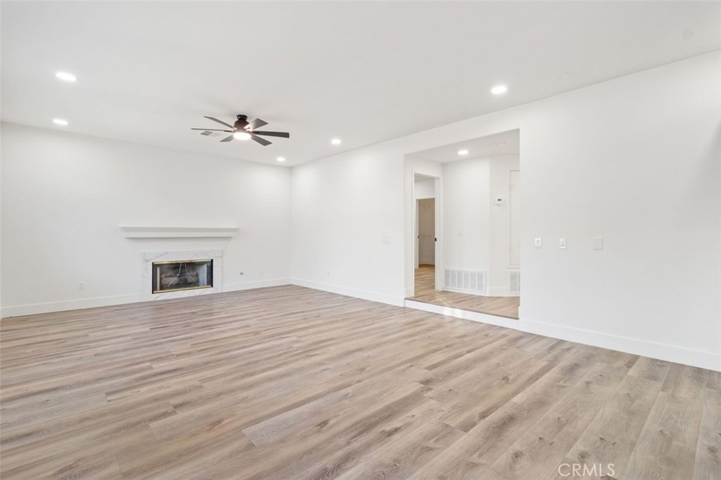 14439 Grandifloras Road Canyon Country, CA 91387 - Photo 10 of 45 a view of an empty room with a ceiling fan window and a fireplace