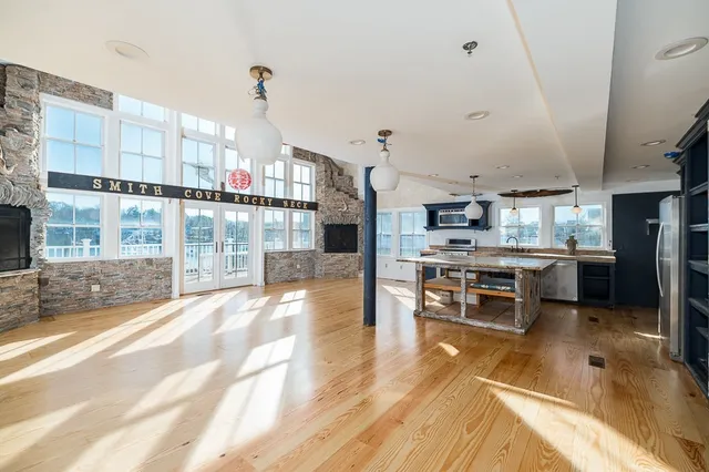a open kitchen with stainless steel appliances kitchen island granite countertop a sink and cabinets