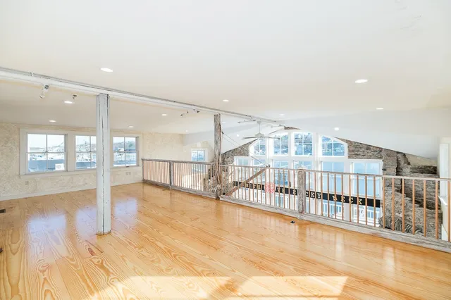 a view of an entryway with wooden floor