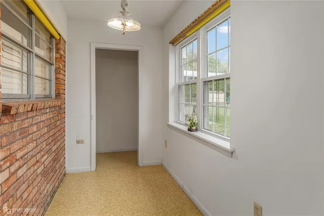 an empty room with closet and a ceiling fan