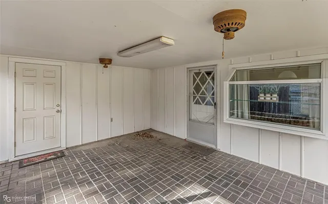 a front view of house with yard and trees in the background