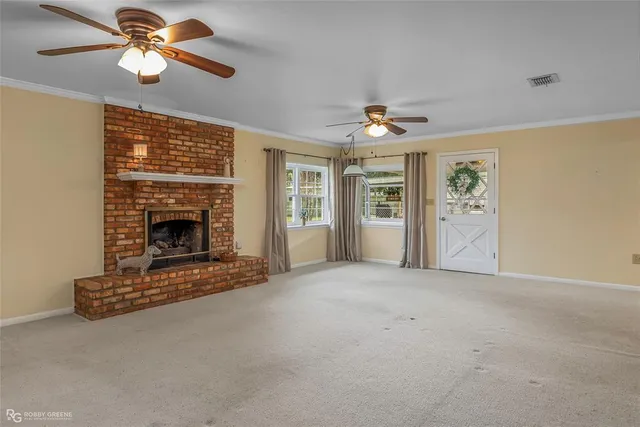 a view of an empty room with a fireplace