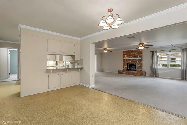 a view of an empty room with a ceiling fan