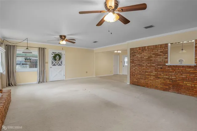 a view of a room with a window and front door