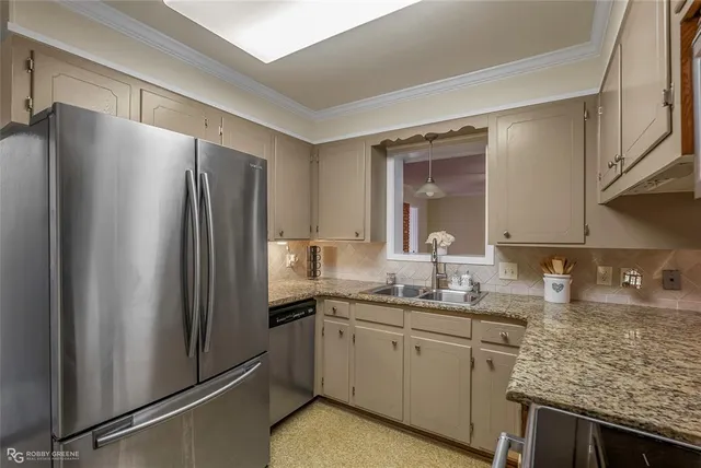 a kitchen with cabinets stainless steel appliances and sink