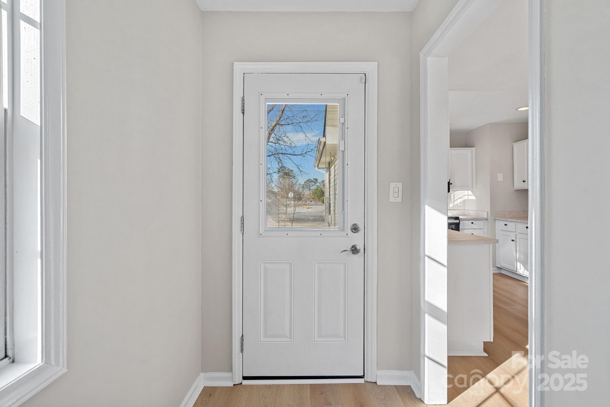 7100 Windsong Way Wingate, NC 28174 - Photo 12 of 26 a view of a hallway with wooden floor and front door
