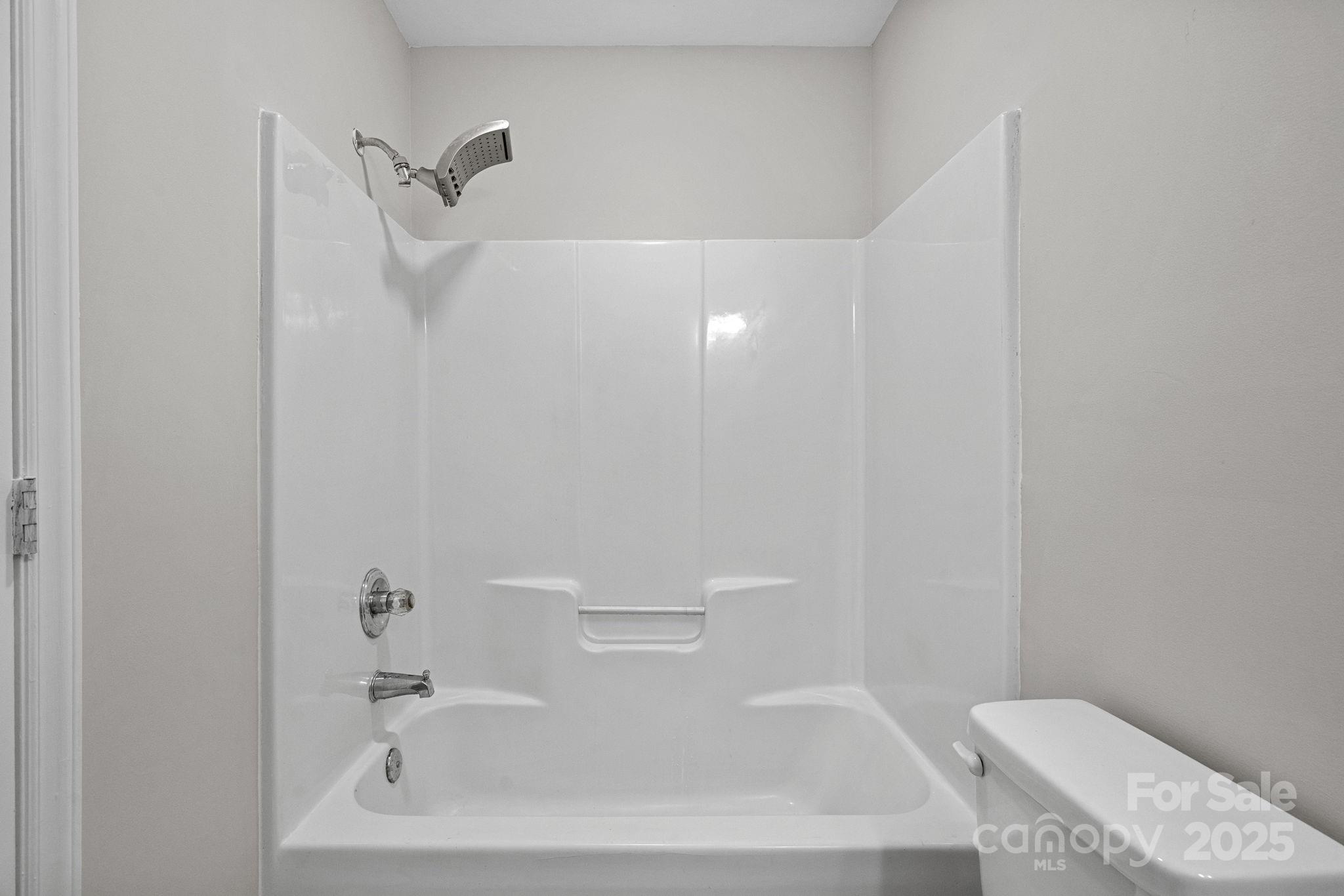 7100 Windsong Way Wingate, NC 28174 - Photo 16 of 26 a bathroom with a bathtub and toilet