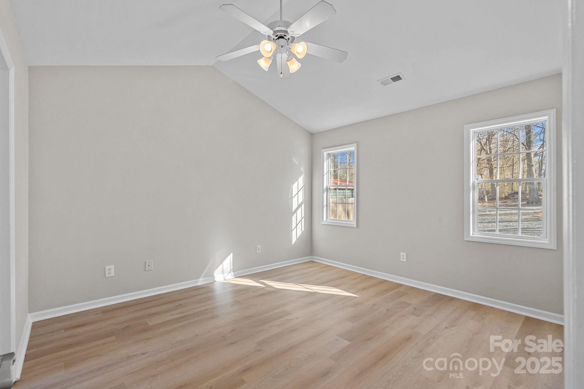 7100 Windsong Way Wingate, NC 28174 - Photo 18 of 26 wooden floor in an empty room with a window