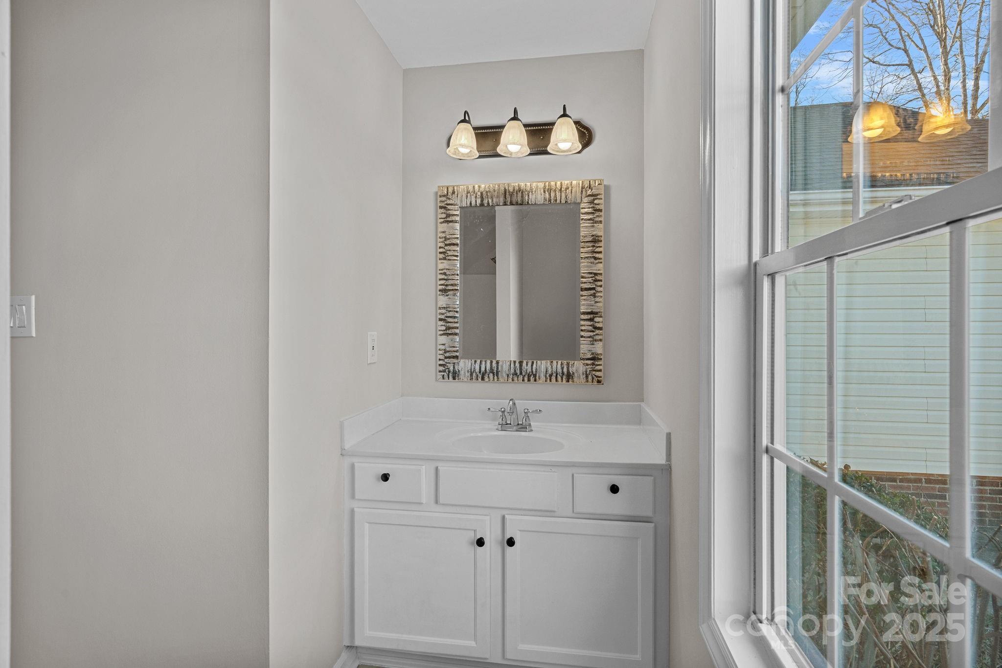 7100 Windsong Way Wingate, NC 28174 - Photo 20 of 26 a bathroom with a sink and a mirror