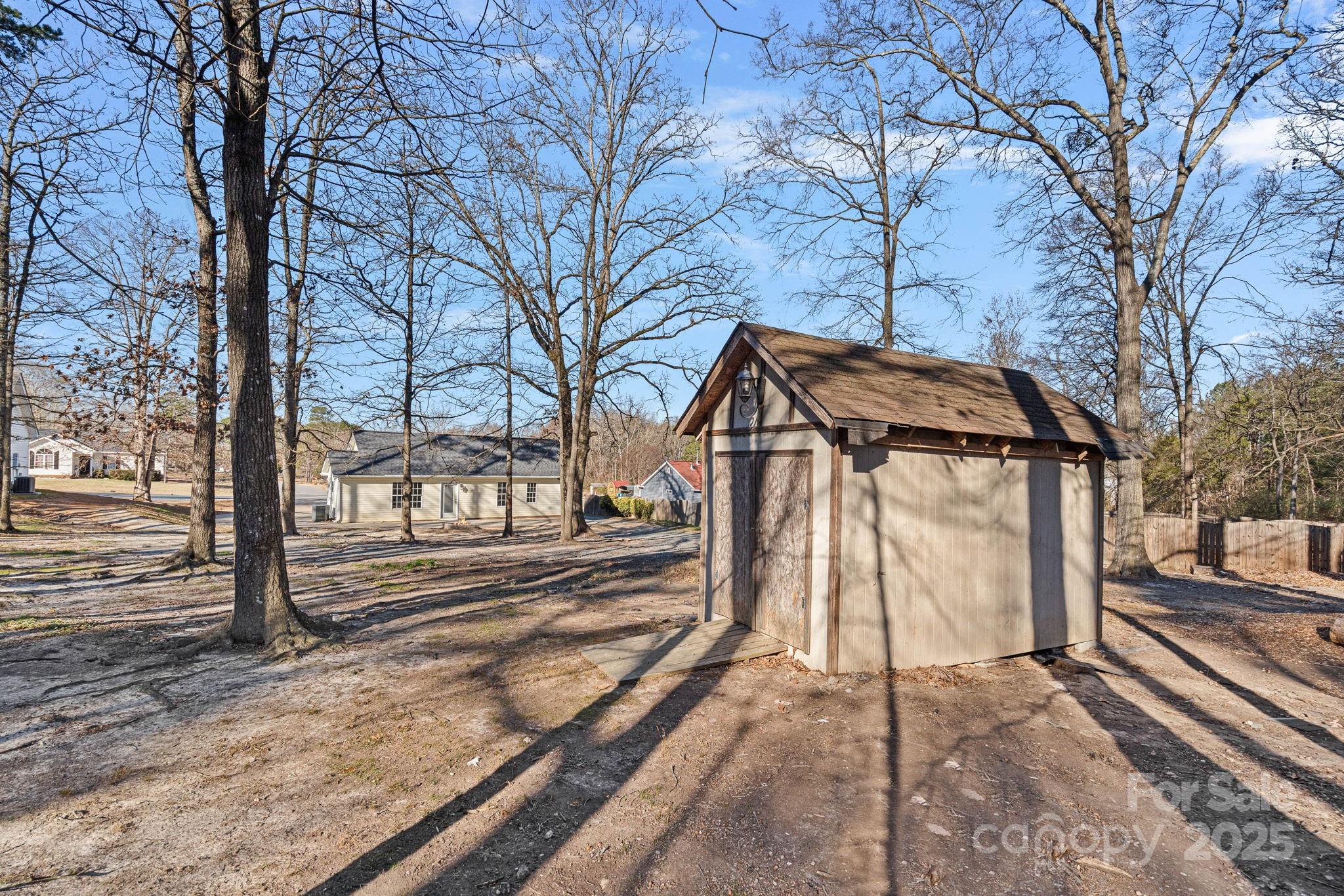 7100 Windsong Way Wingate, NC 28174 - Photo 24 of 26 a view of a house with a yard and wooden fence