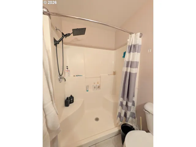 a bathroom with a shower and a toilet