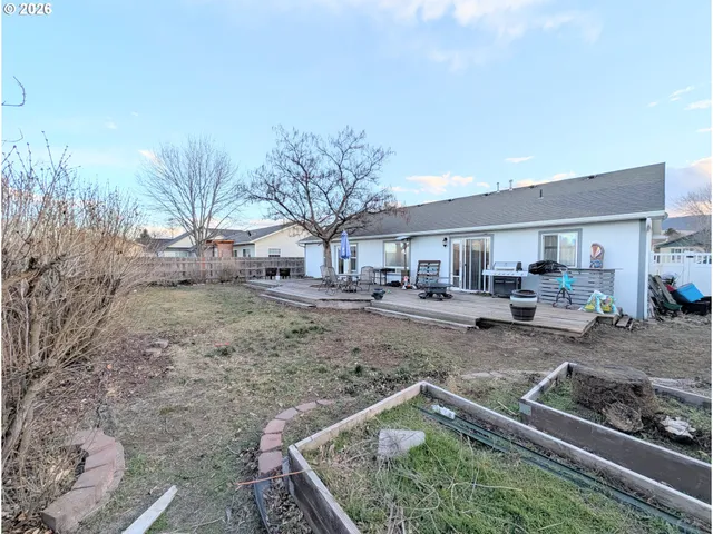 a view of a backyard with plants and outdoor seating