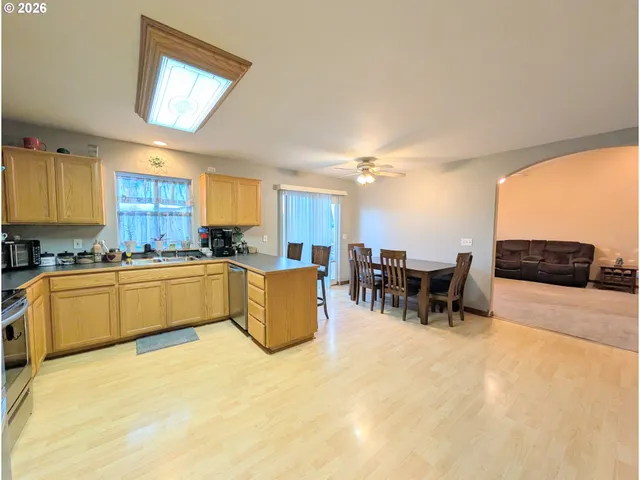 a large kitchen with a large counter top furniture and appliances